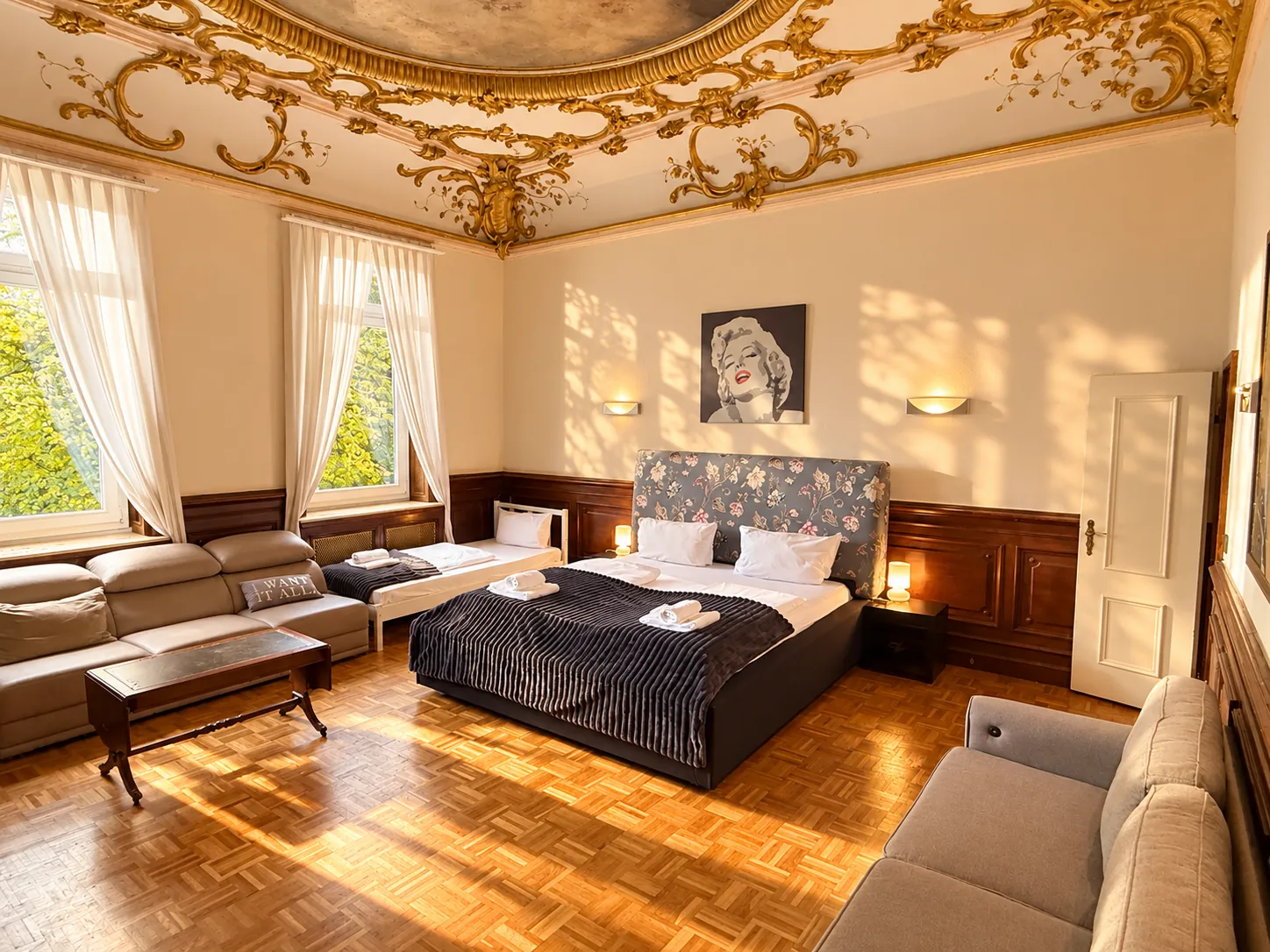 Large double room with stucco ceiling, sofa and seating area