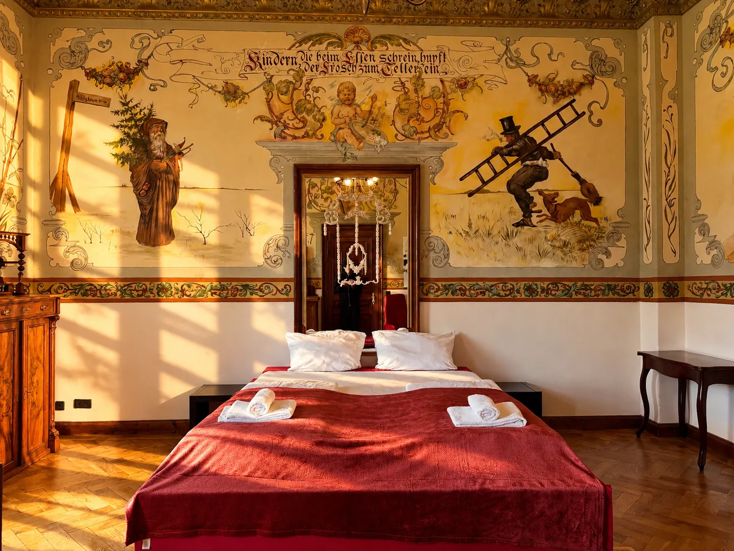 Double bed in front of a painted historic wall