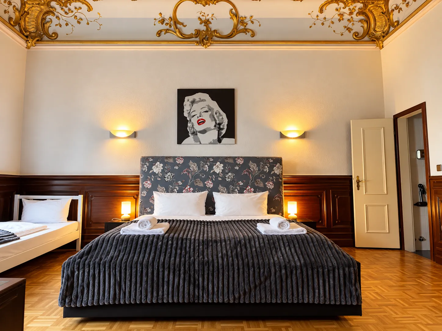 Double bed with wood panelling and wall art