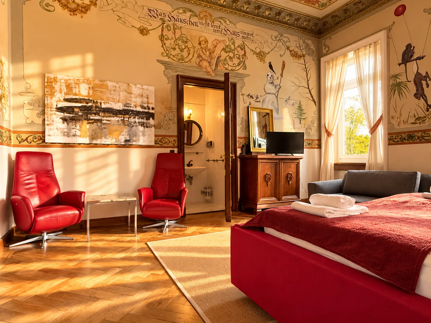 Red armchairs and murals in the room