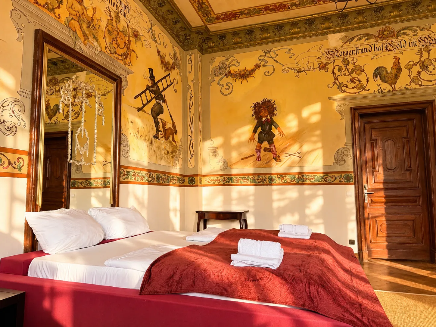 Bed facing murals and a mirror