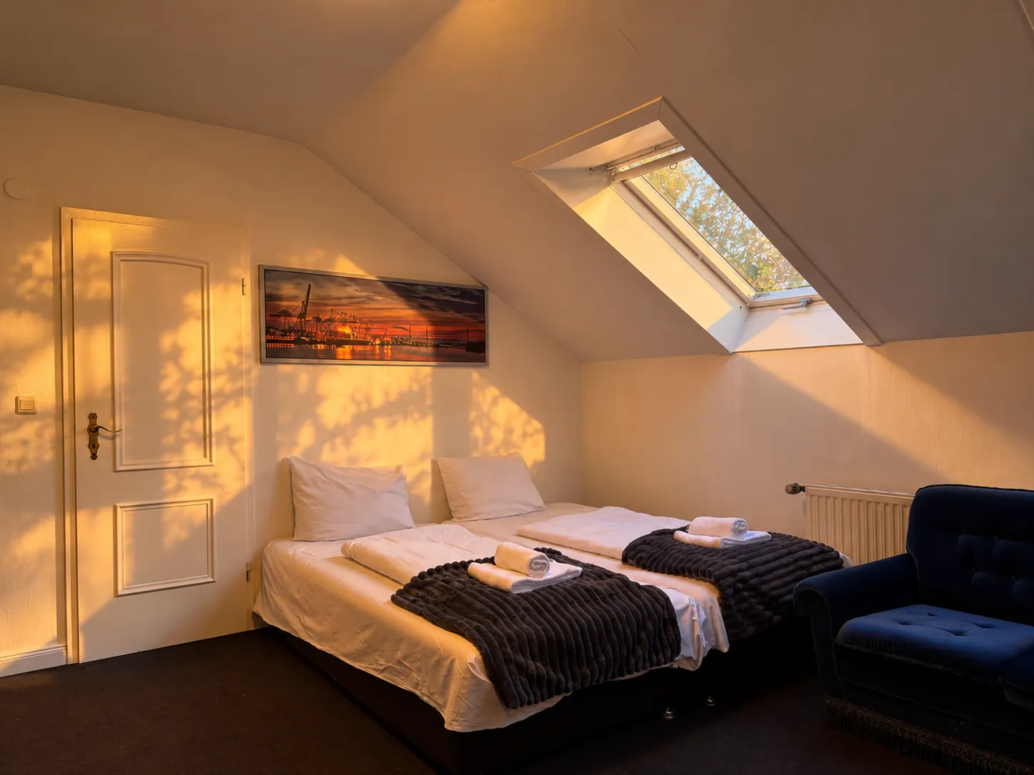 Two beds in the attic room with skylight